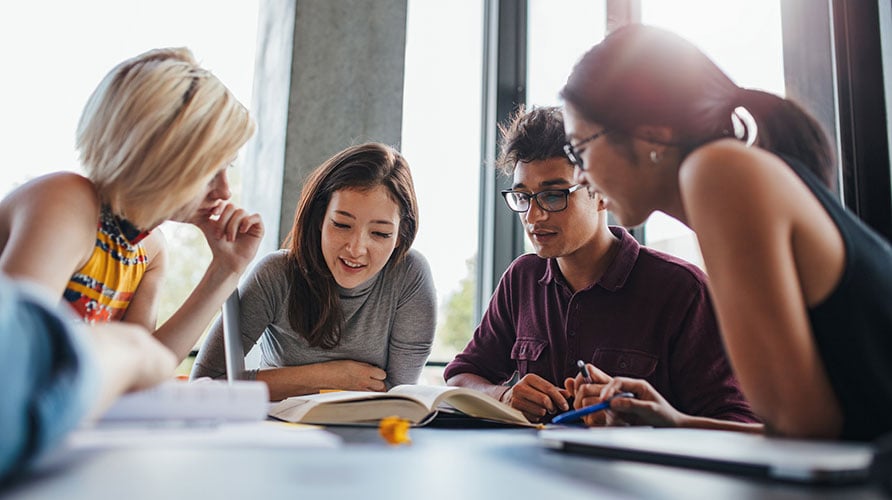 People around a table learning